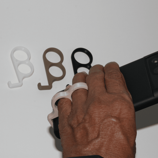 Hand holding a phone with white, brown, and black rubber bands